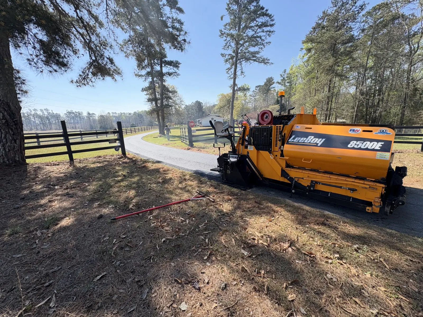 Fresh asphalt paving equipment laying a smooth blacktop surface