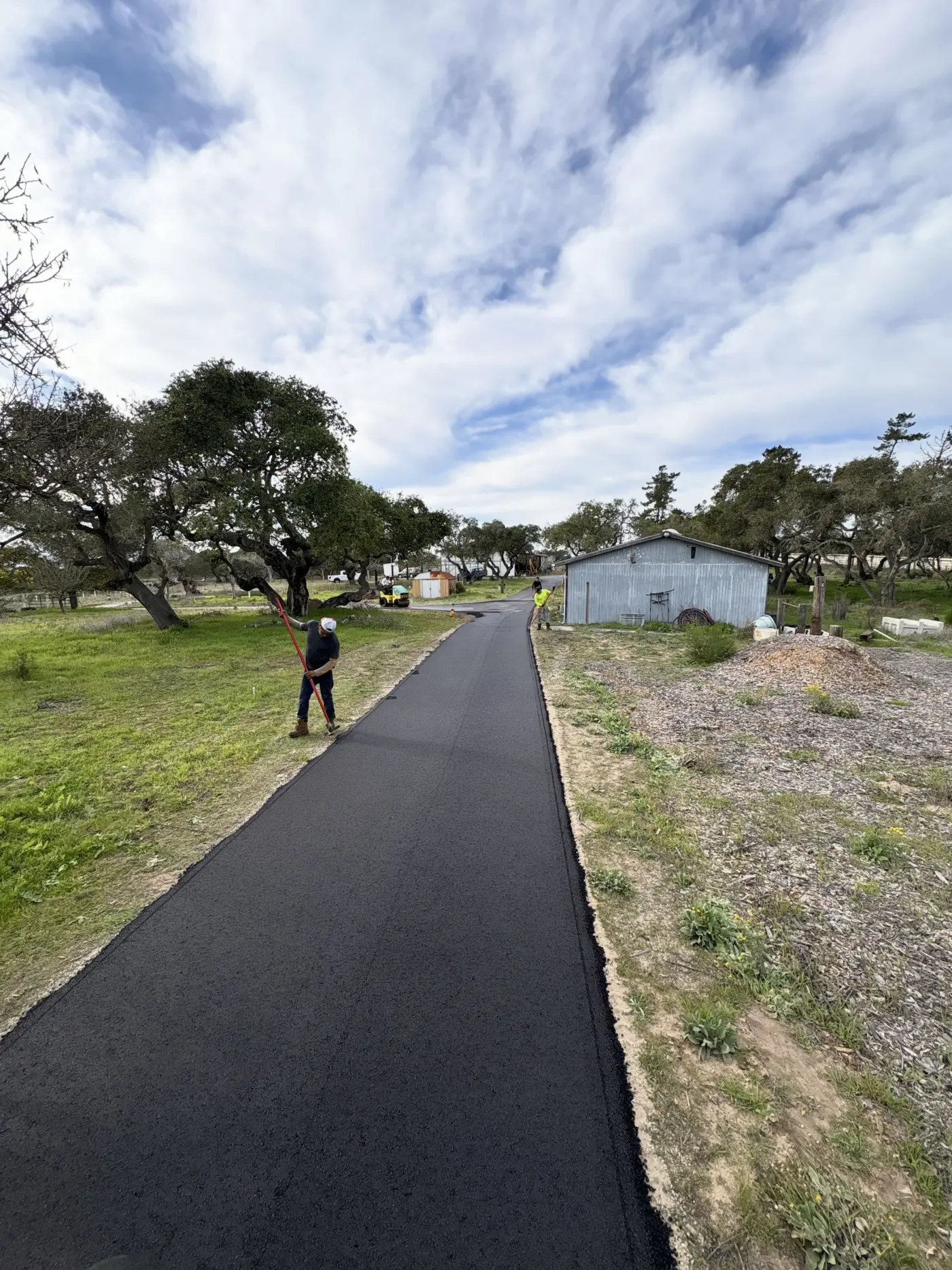 Finished residential asphalt driveway with clean edges