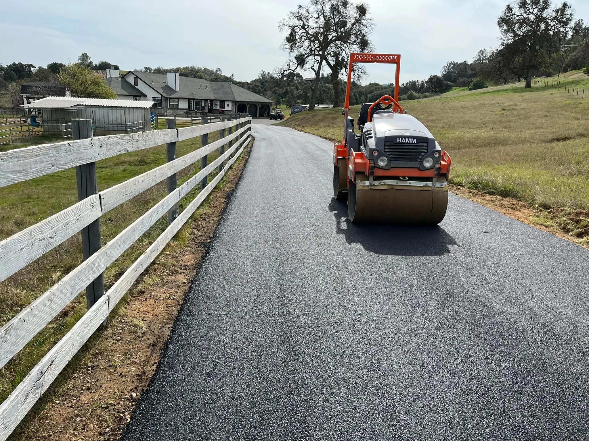 Roller compacting asphalt on a paved road